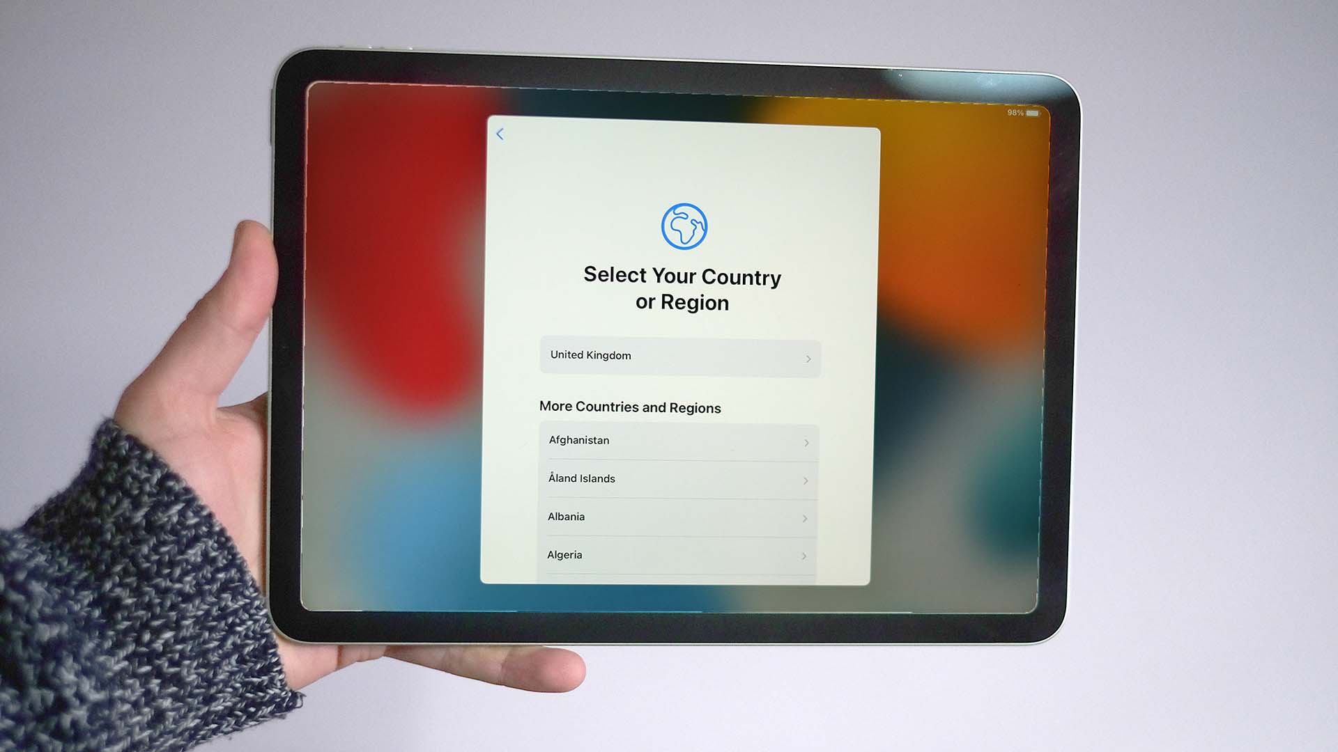 An iPad with the screen showing the options for selecting a country or region