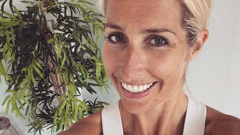 Jade Gooding, yoga instructor; headshot of a smiling blonde woman with a houseplant in the background