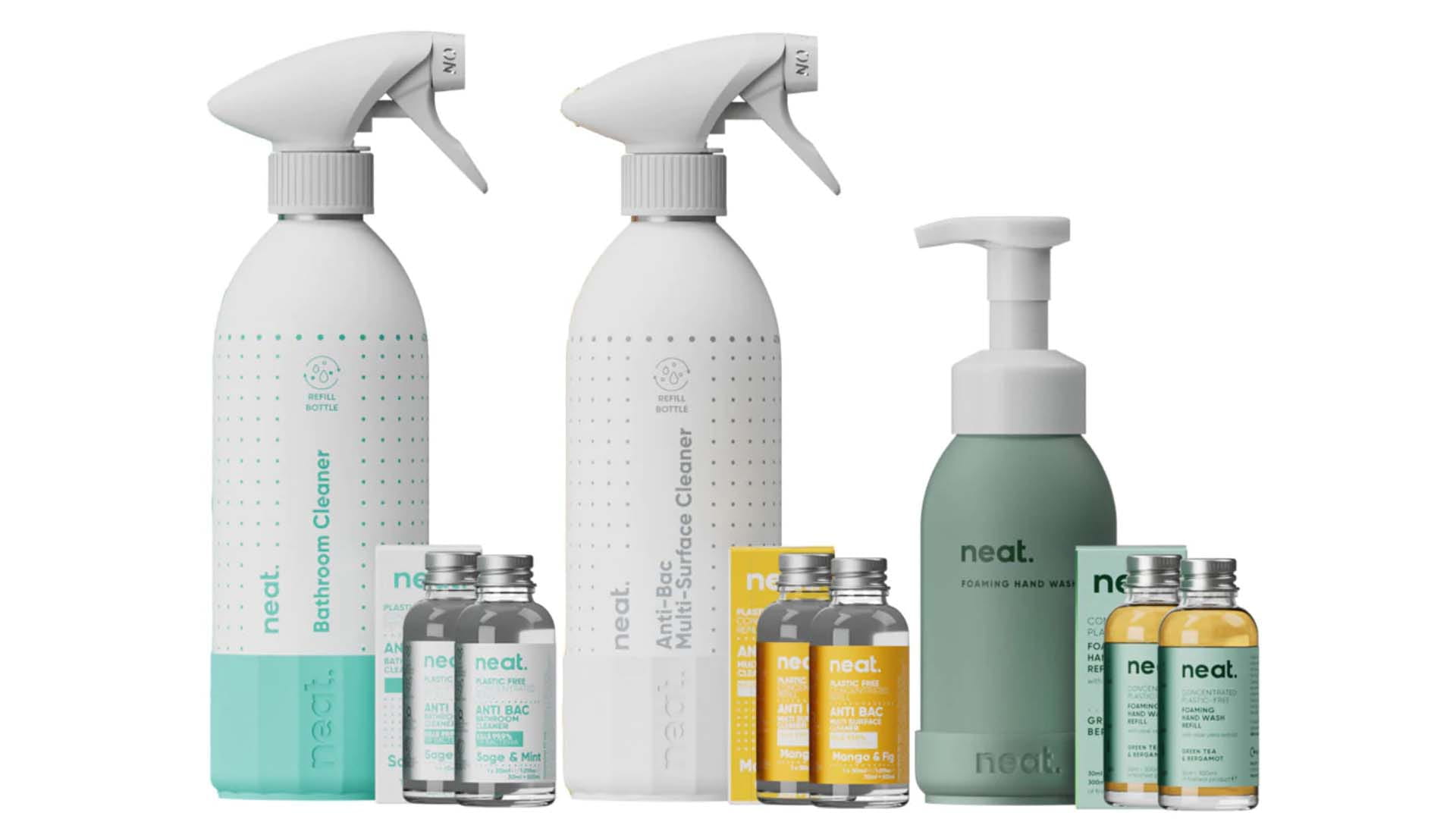 A selection of Neat eco-friendly cleaning products; three re-usable aluminium bottles with small glass refill bottles