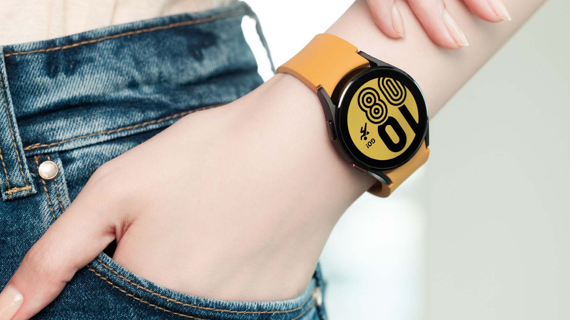 A woman with her hand in her pocket wearing a smartwatch