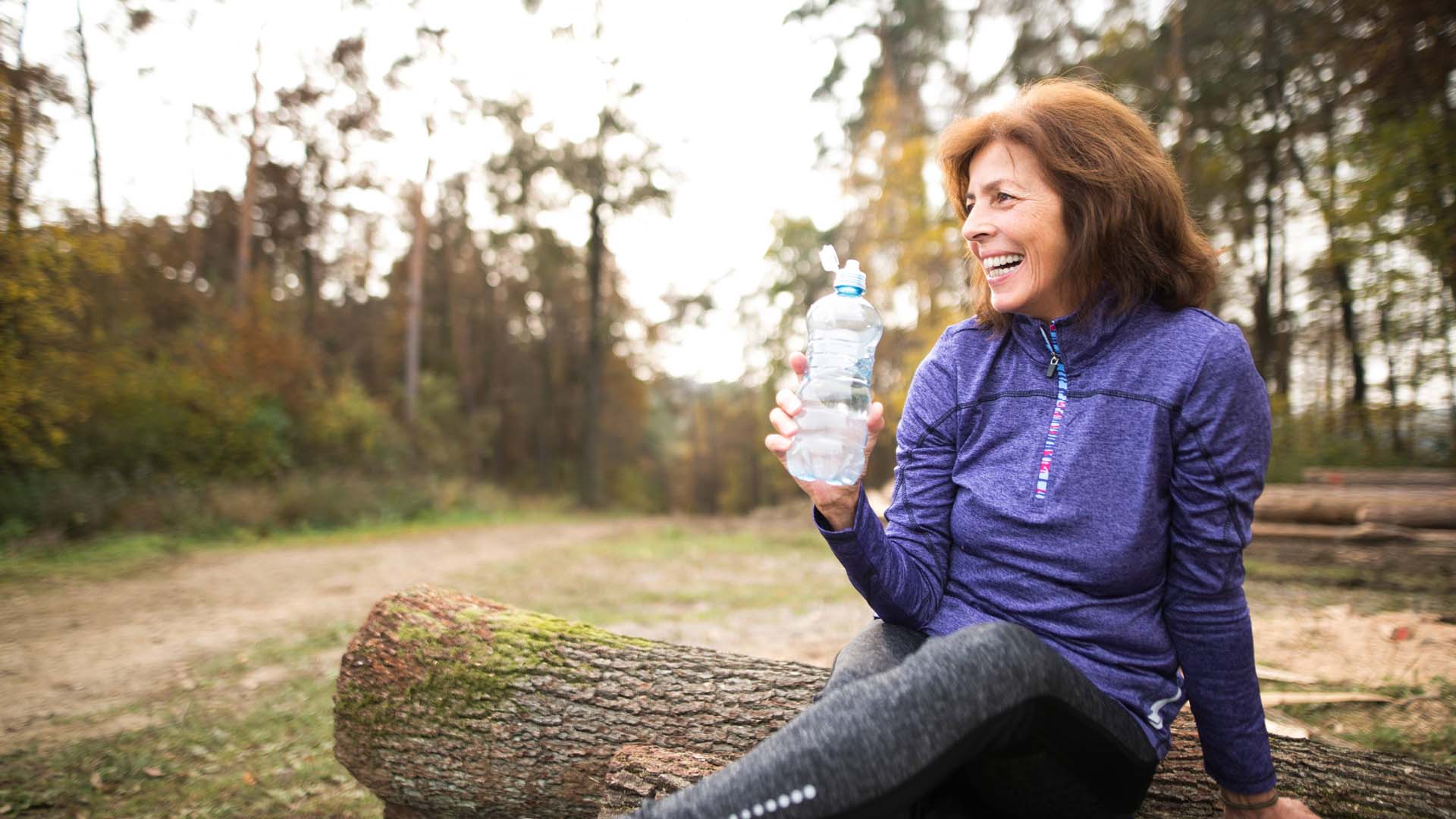 Woman with water bottle after exercise