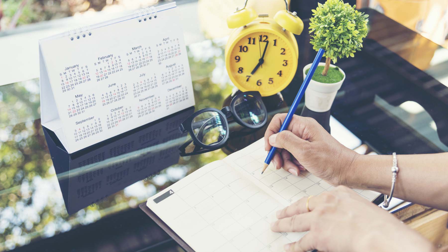 person planning their schedule using a calendar 