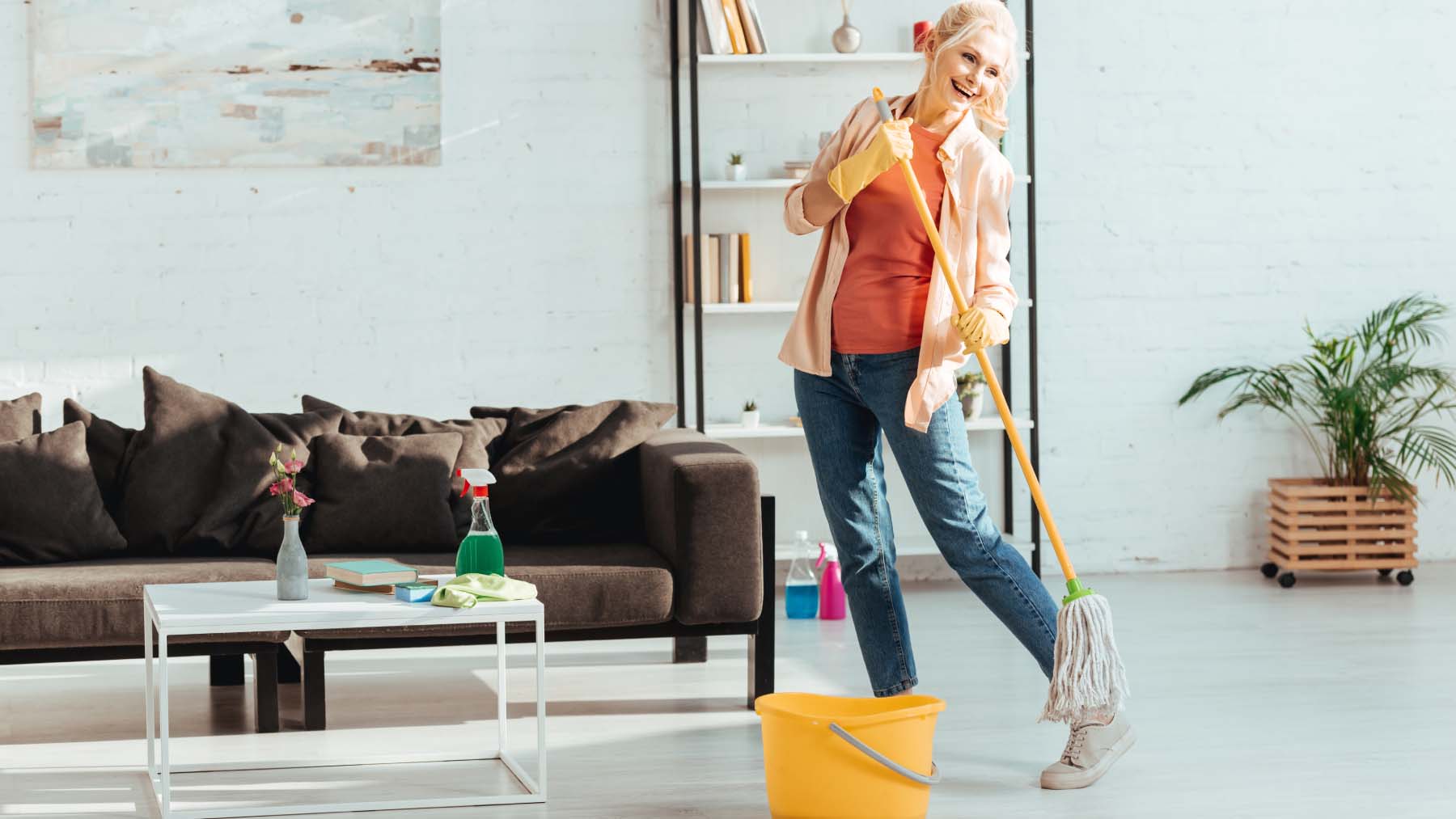 Woman smiling cleaning mop