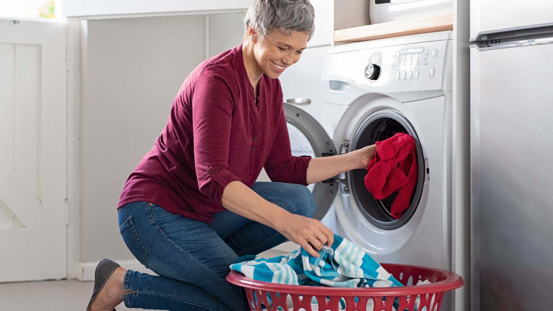 Woman loading a washing machine