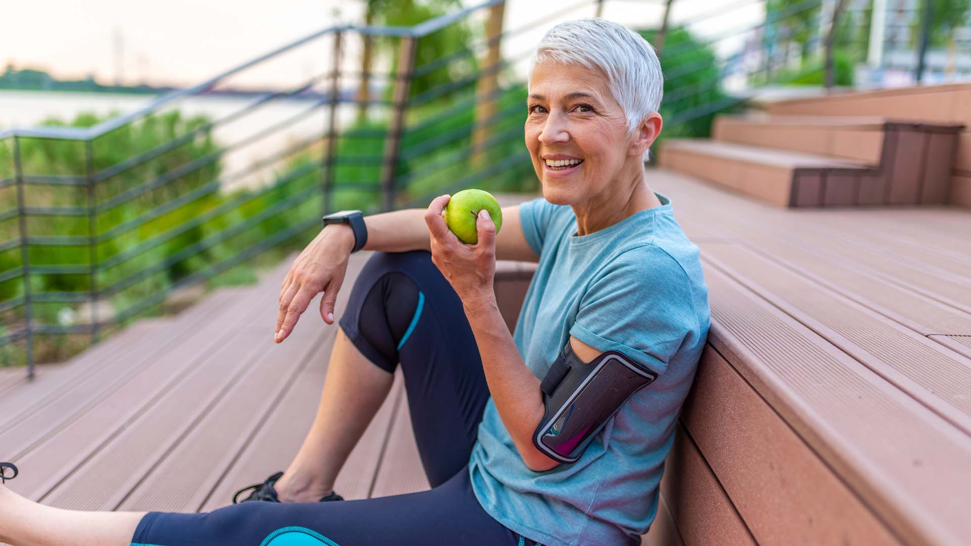 lady sitting down eating an apple