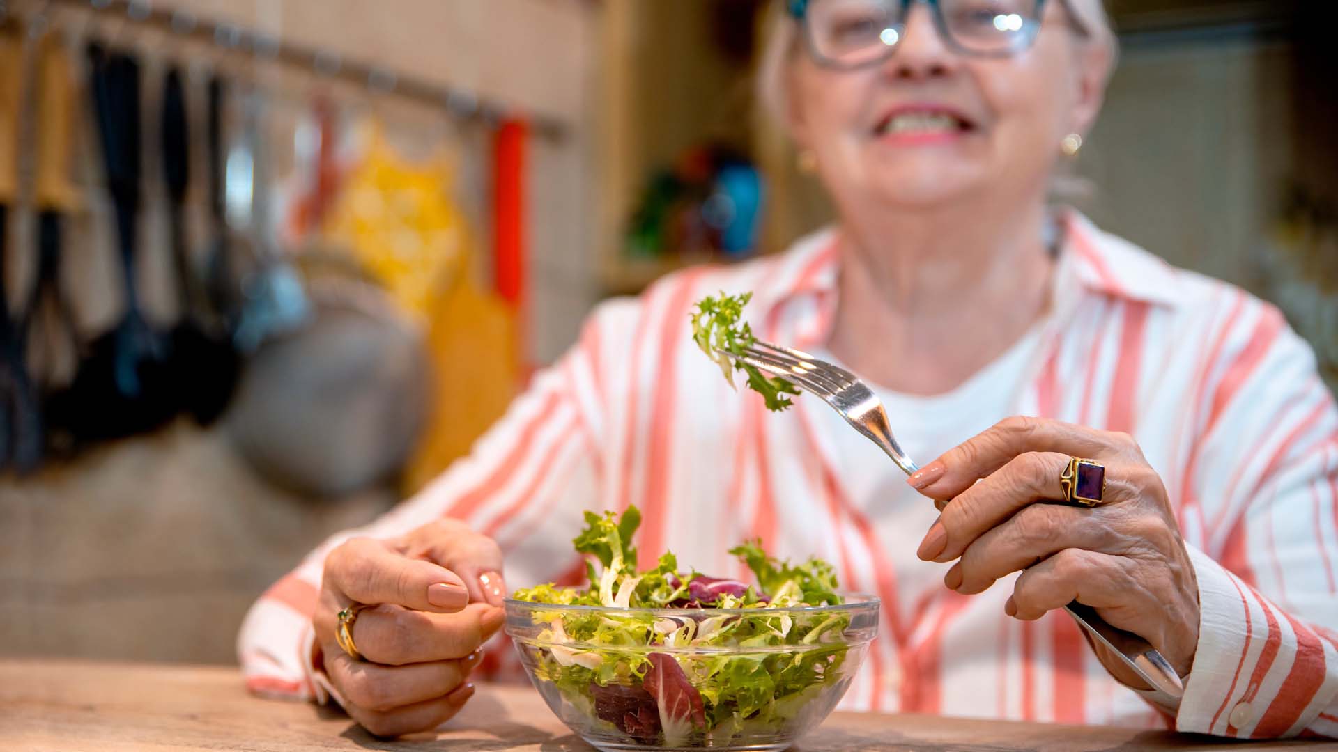 woman eating salad from a bowl