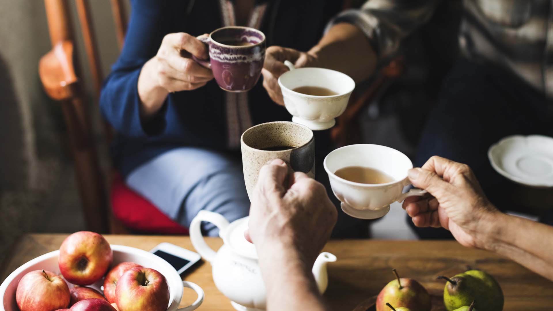 group of people clinking teacups