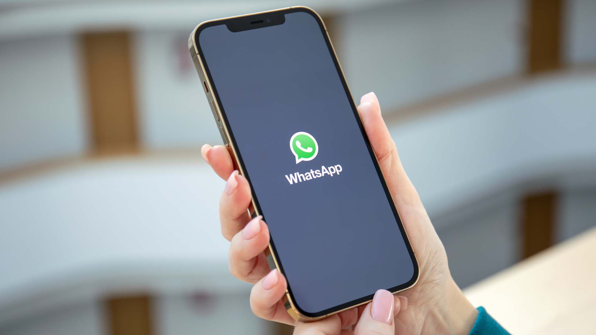 A phone with the WhatsApp app displayed on the screen