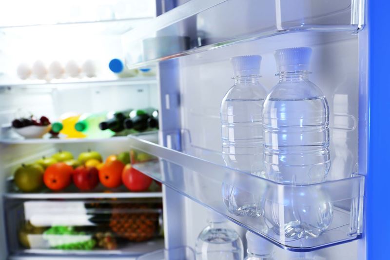 Bottled water in an open fridge