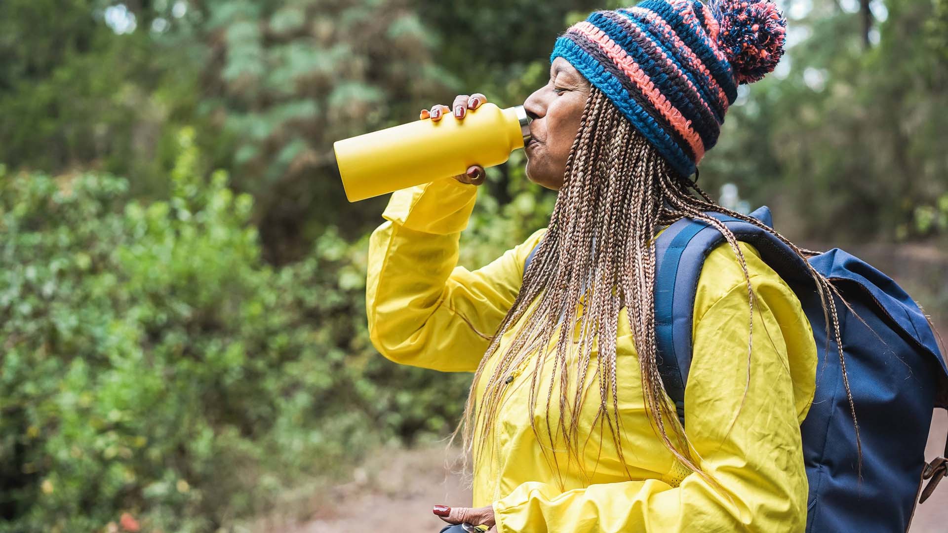 woman drinking water on a hike