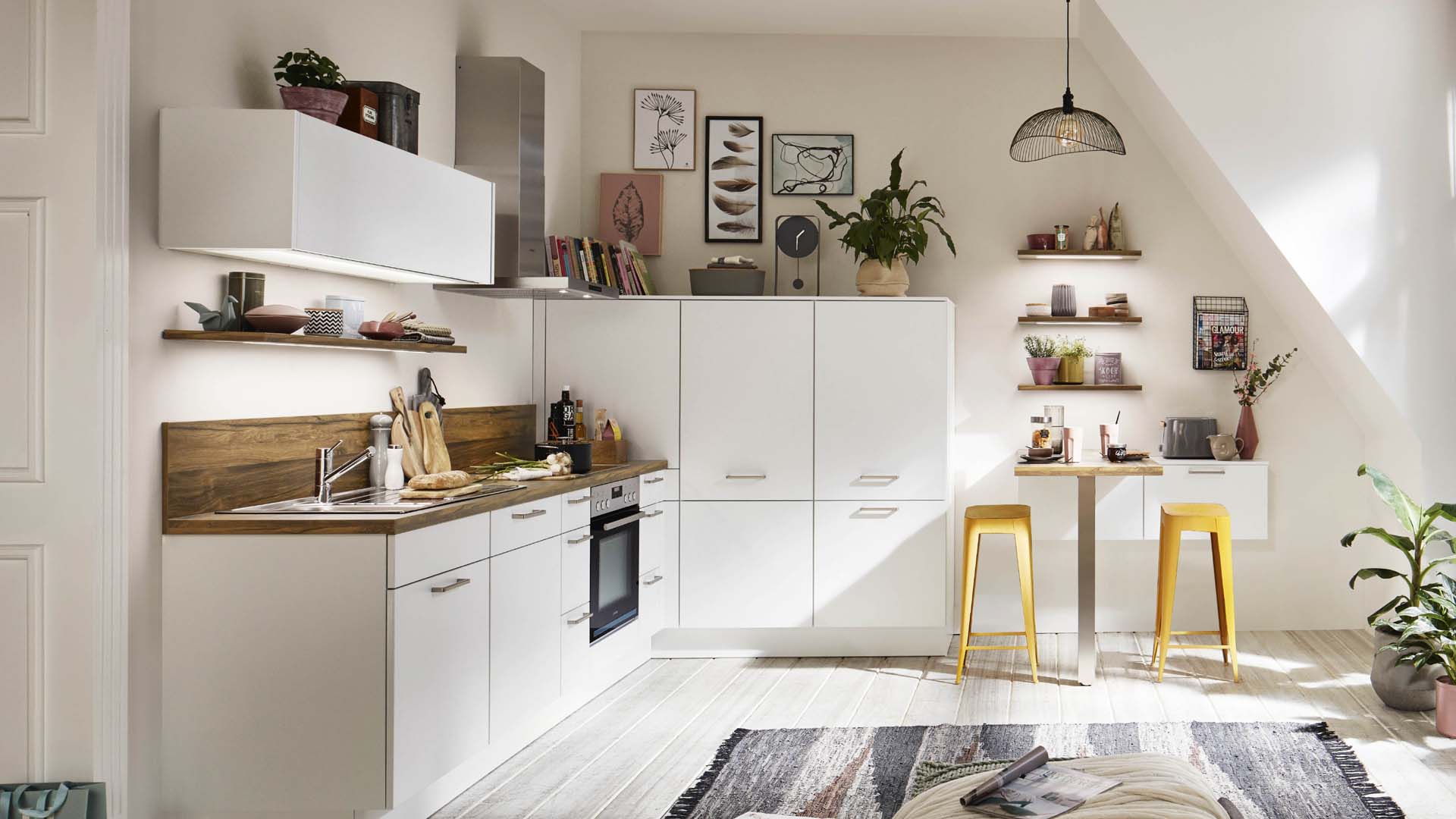 A white airy kitchen with a slanted ceiling