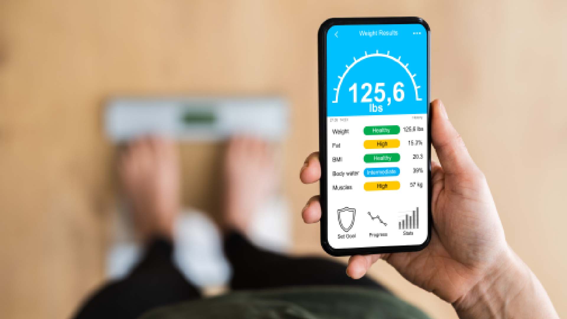 Person looking at a weight app on their phone
