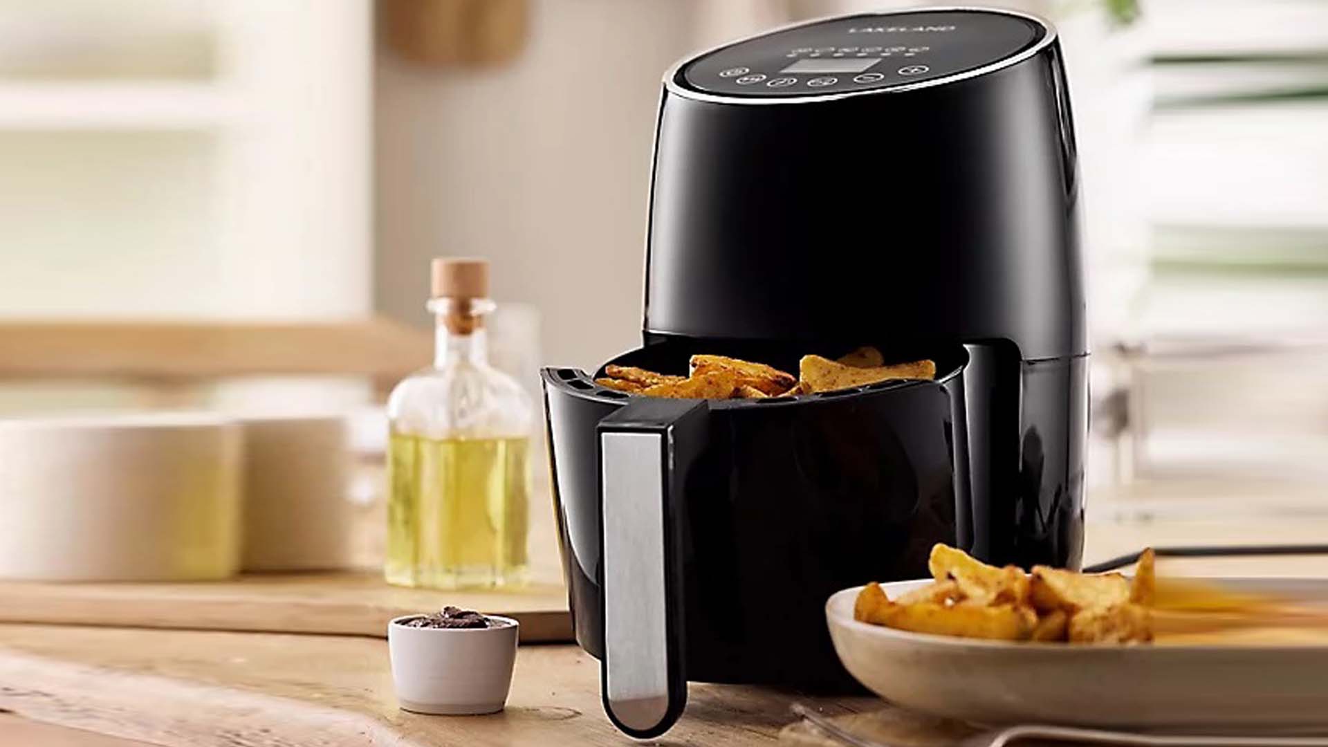 one air fryer on the side in the kitchen with oil next to it