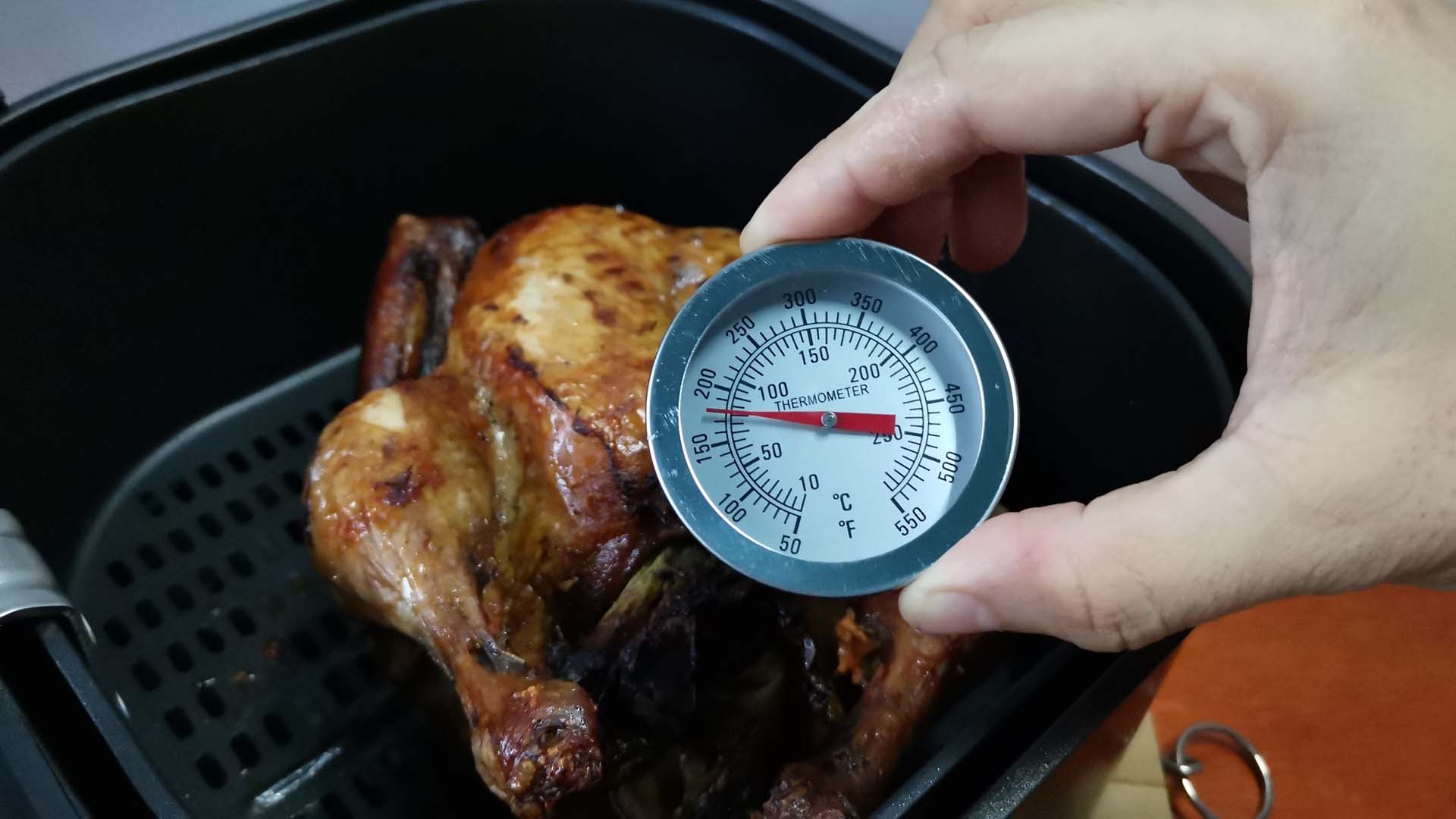 meat thermometer on an air fryer chicken