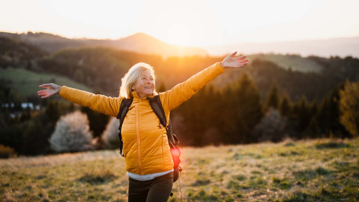 Woman hiking outdoors in nature at sunset