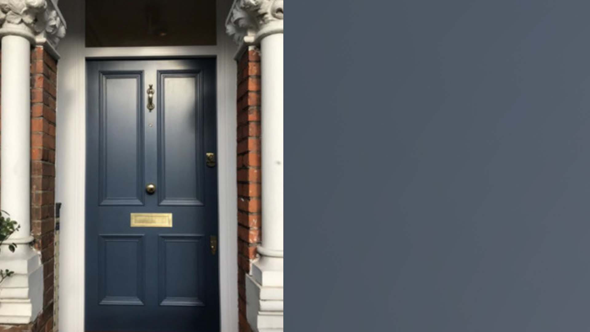 A dark blue-grey front door with a swatch of the colour next to it