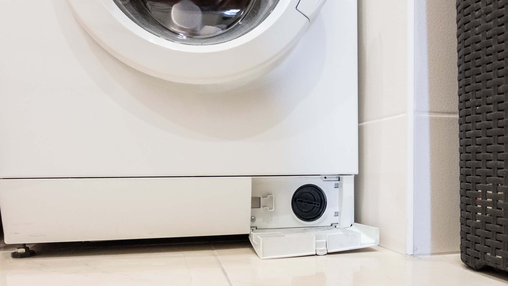 front of washing machine with filter door open at base