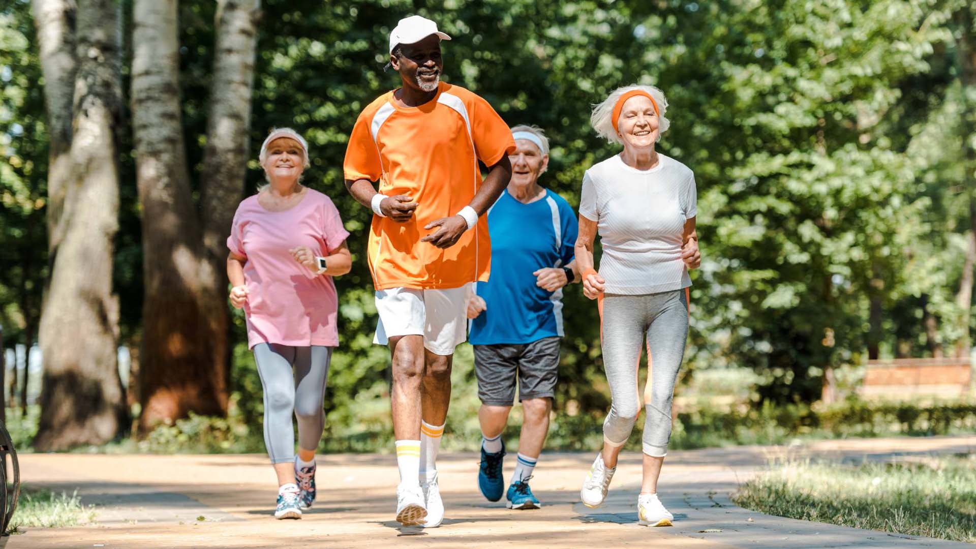 sportive multicultural and senior men and women running in park