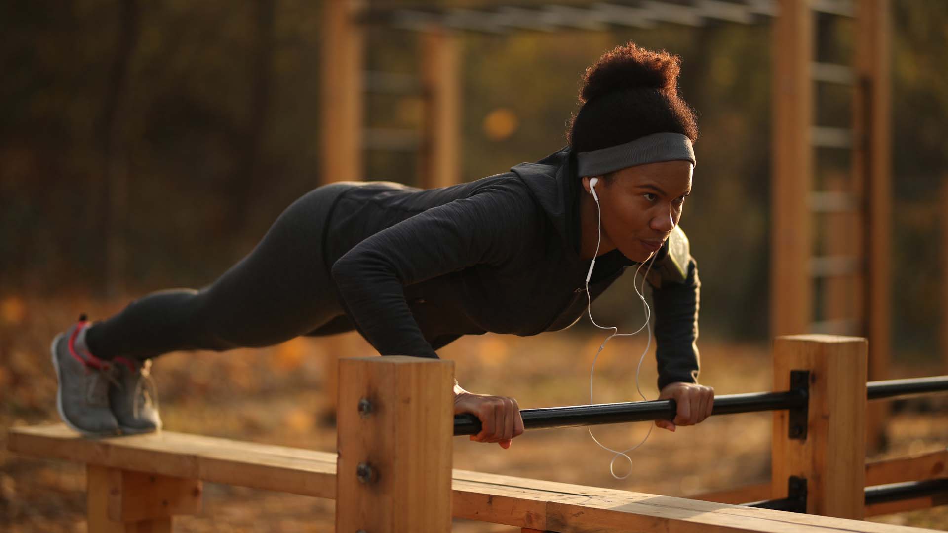 Woman doing press ups on outdoor apparatus 