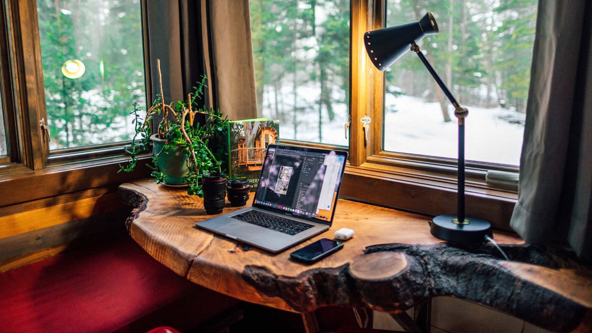 natural wood desk in conservatory style space