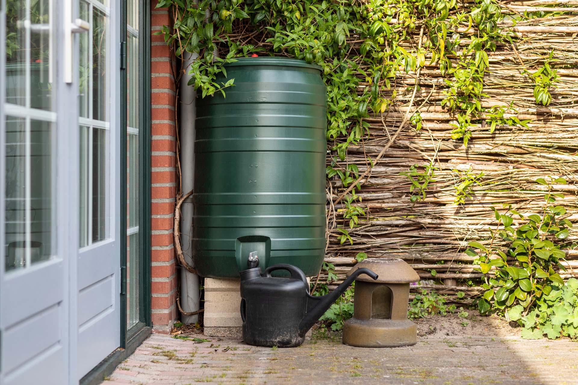 Water saving container in a garden