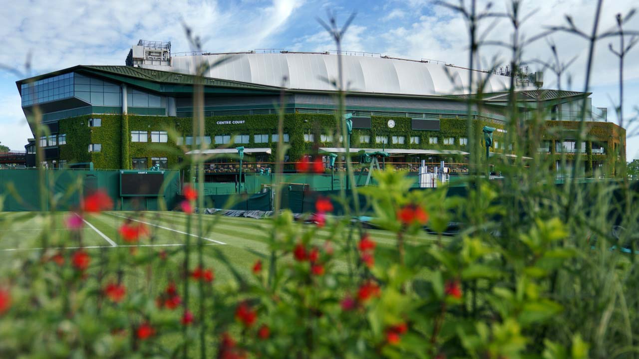 A view through the flowers behind Court 8 looking towards Centre Court