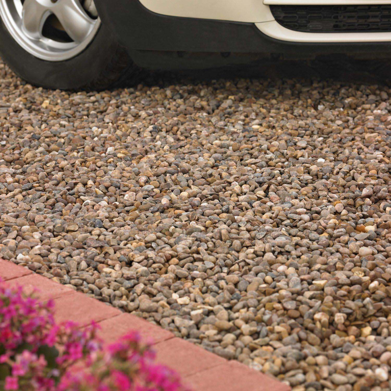 Blooma naturally rounded brown decorative stones laid as a driveway