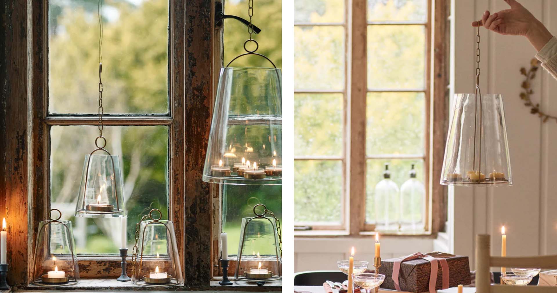 Glass candle lanterns hanging in front of a window
