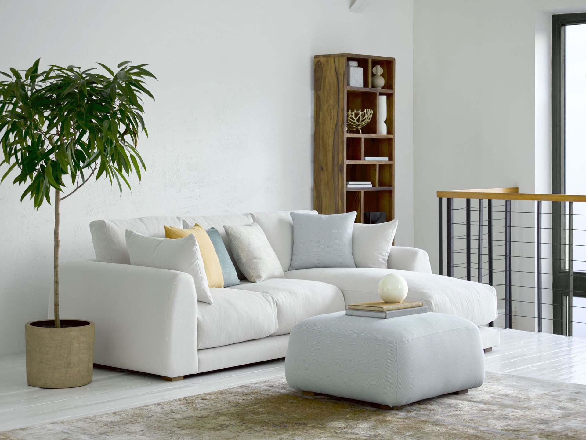 A white sofa in a spacious room