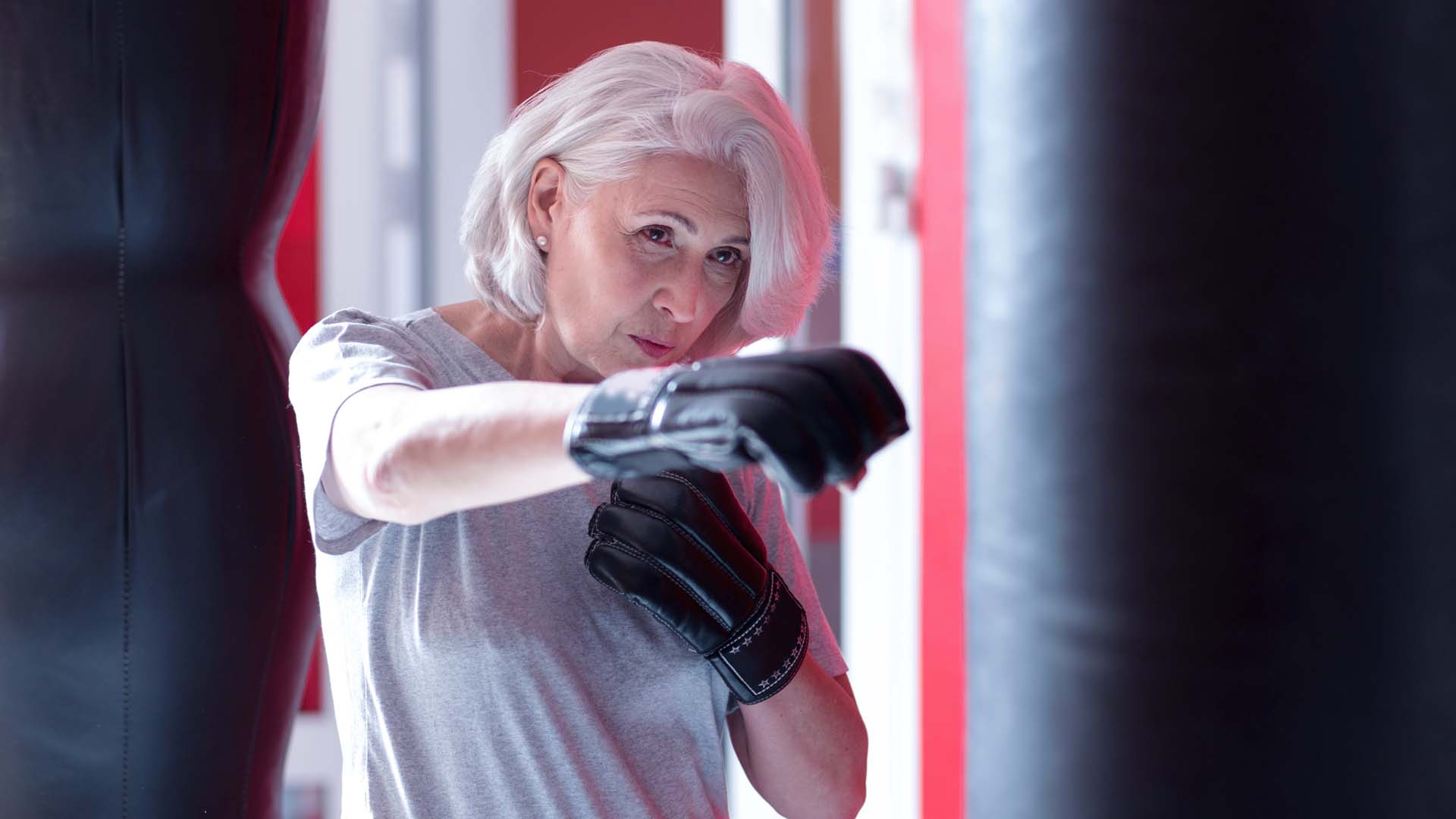 Mature woman shadowing boxing