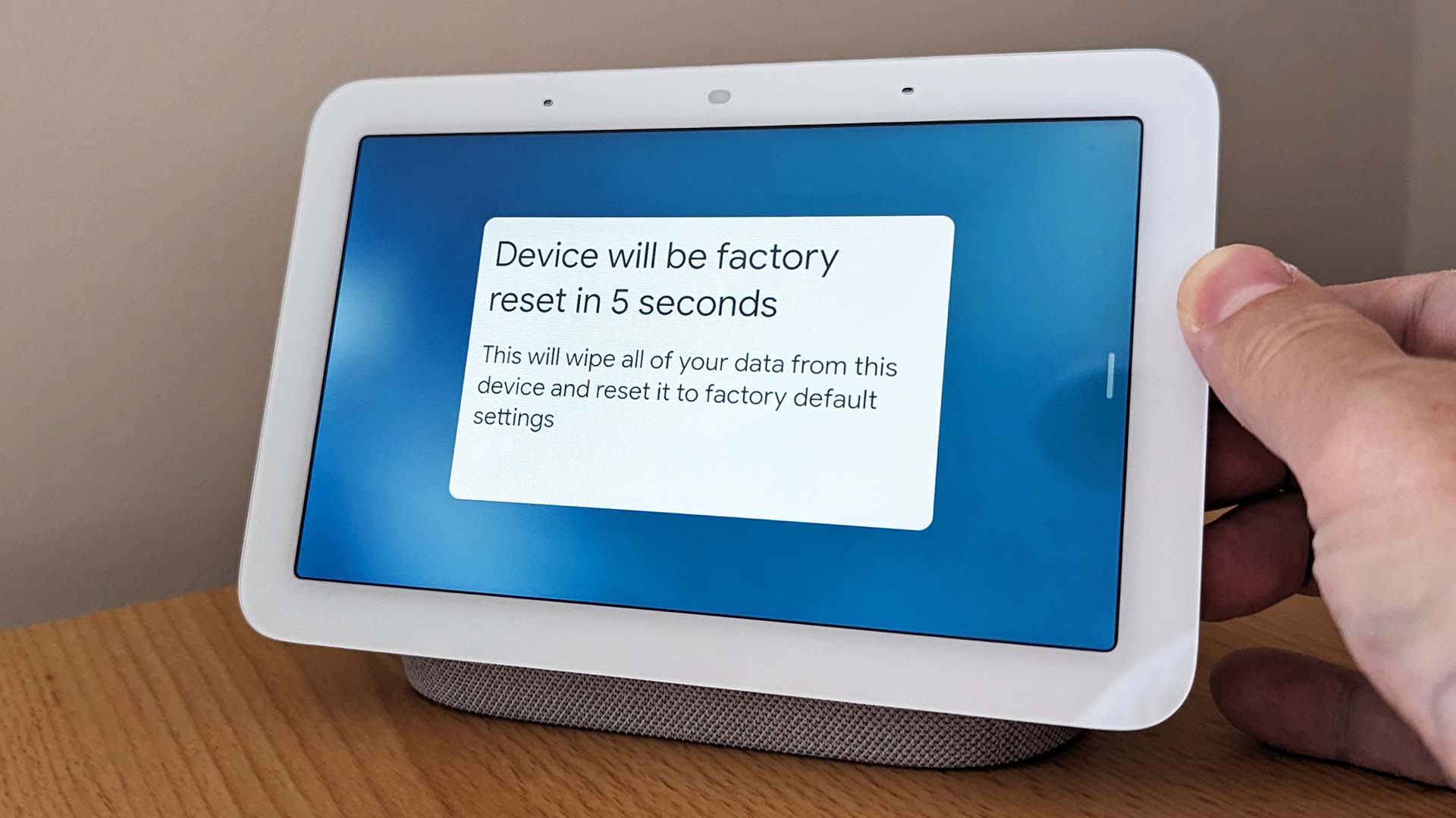 image of someone resetting their google nest tablet