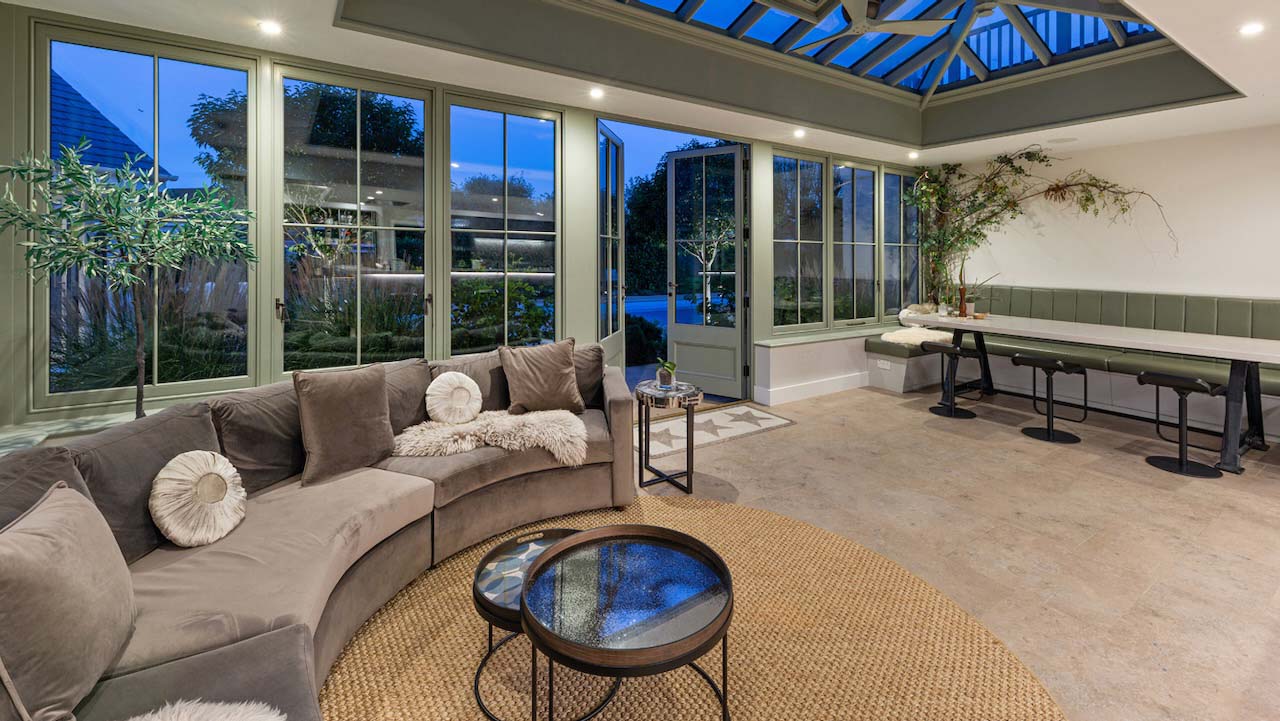 huge conservatory with sofas and dining table
