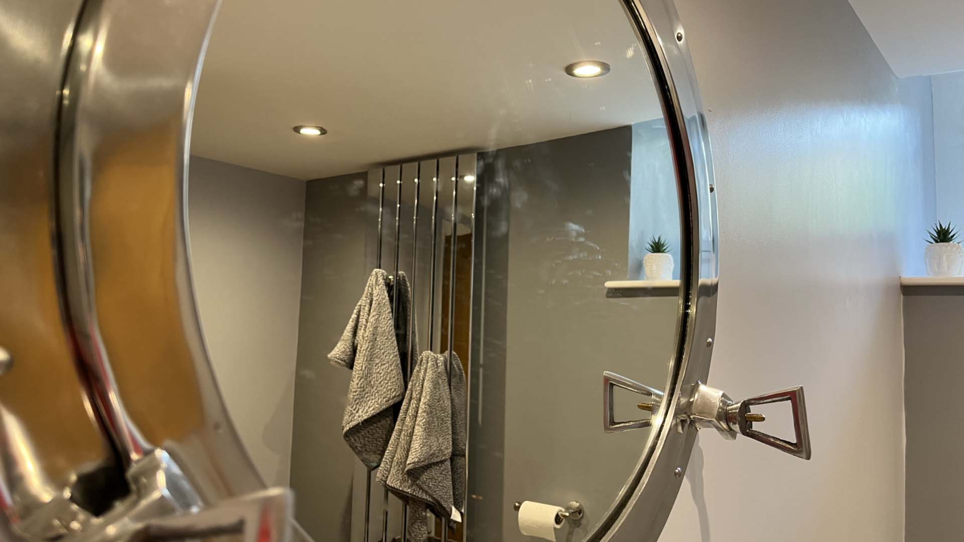 A mirror that needs a clean in a bathroom