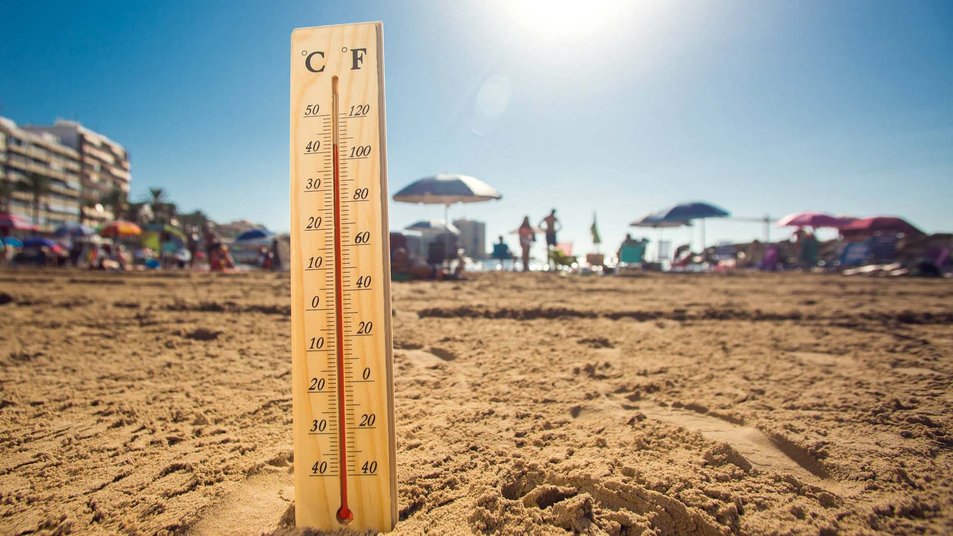 A thermometer on a beach in hot weather