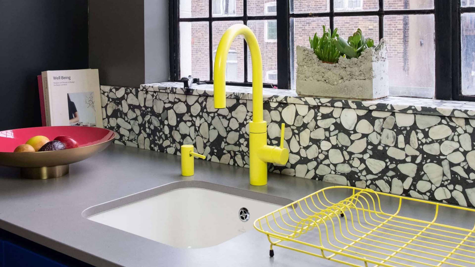 Yellow mixer tap in kitchen