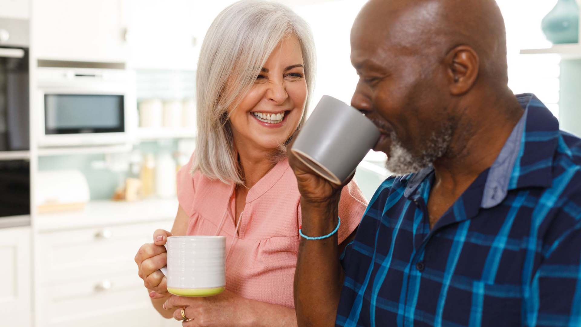 Mature couple drinking tea and smiling