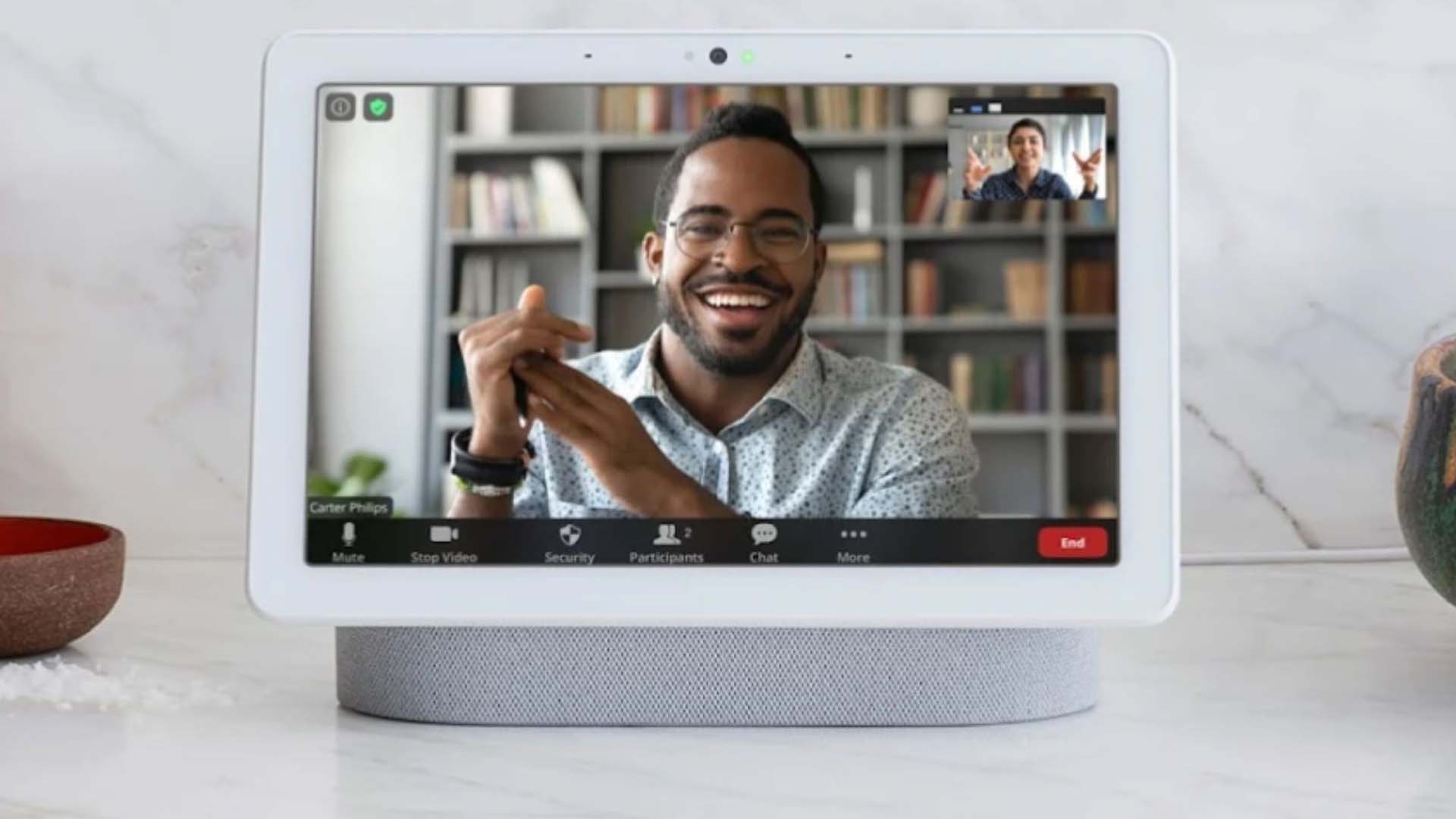 A video call with a smiling man on a Google Nest hub