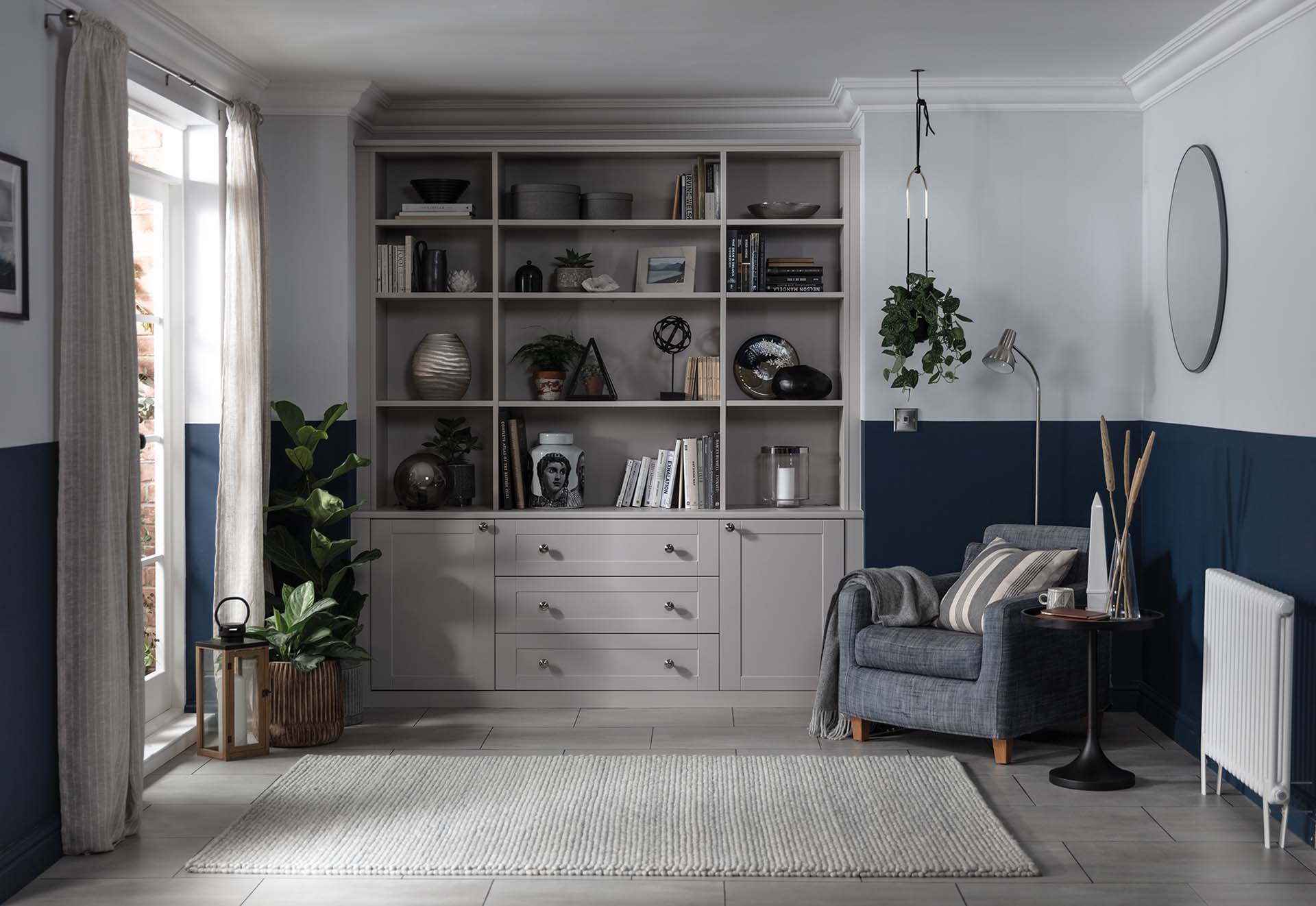 large bookshelf at the end of the room with knick knacks and books on the shelf