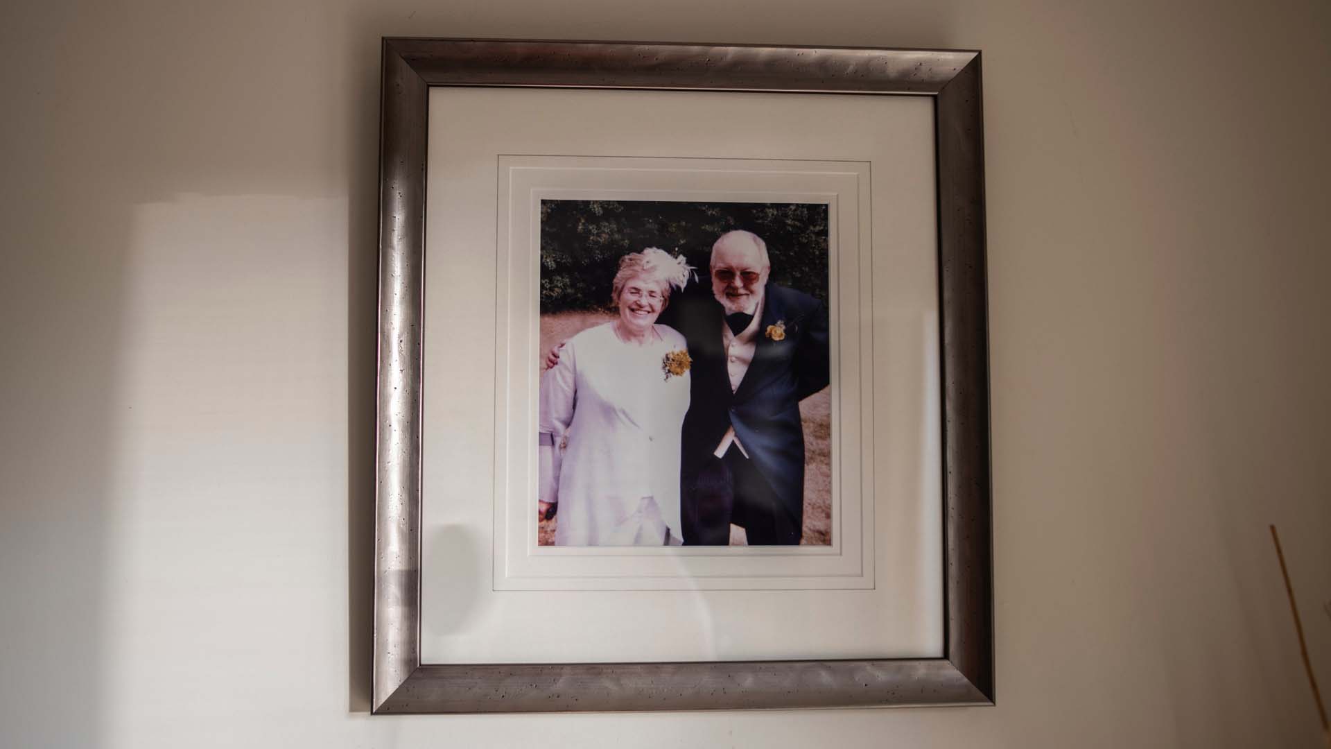 A framed photgraph on the wall of Sheila and Jack