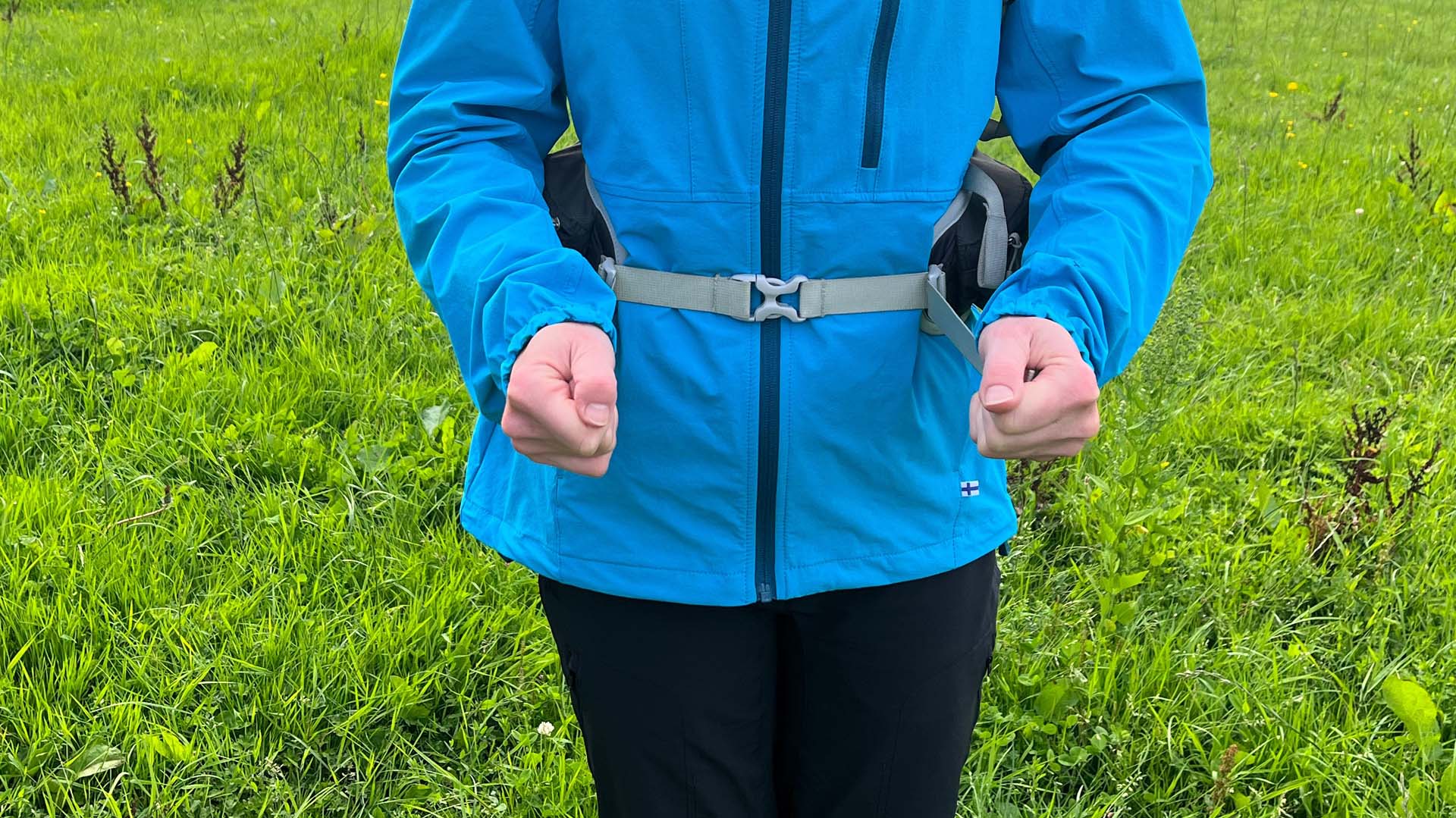 A demonstration of the hip belt strap being adjusted