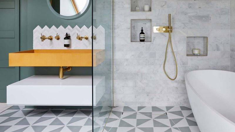 A modern bathroom with patterned tiles on the floor