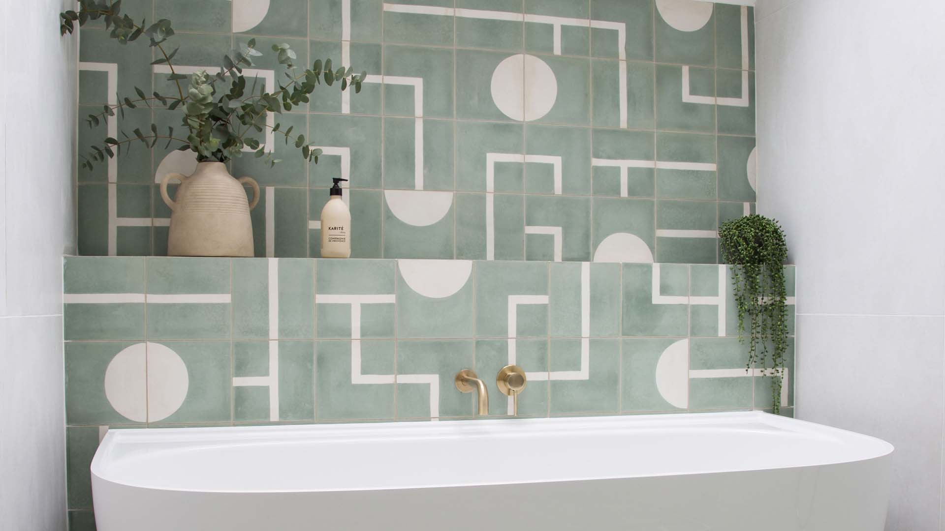 Green geometric tiles over a sink