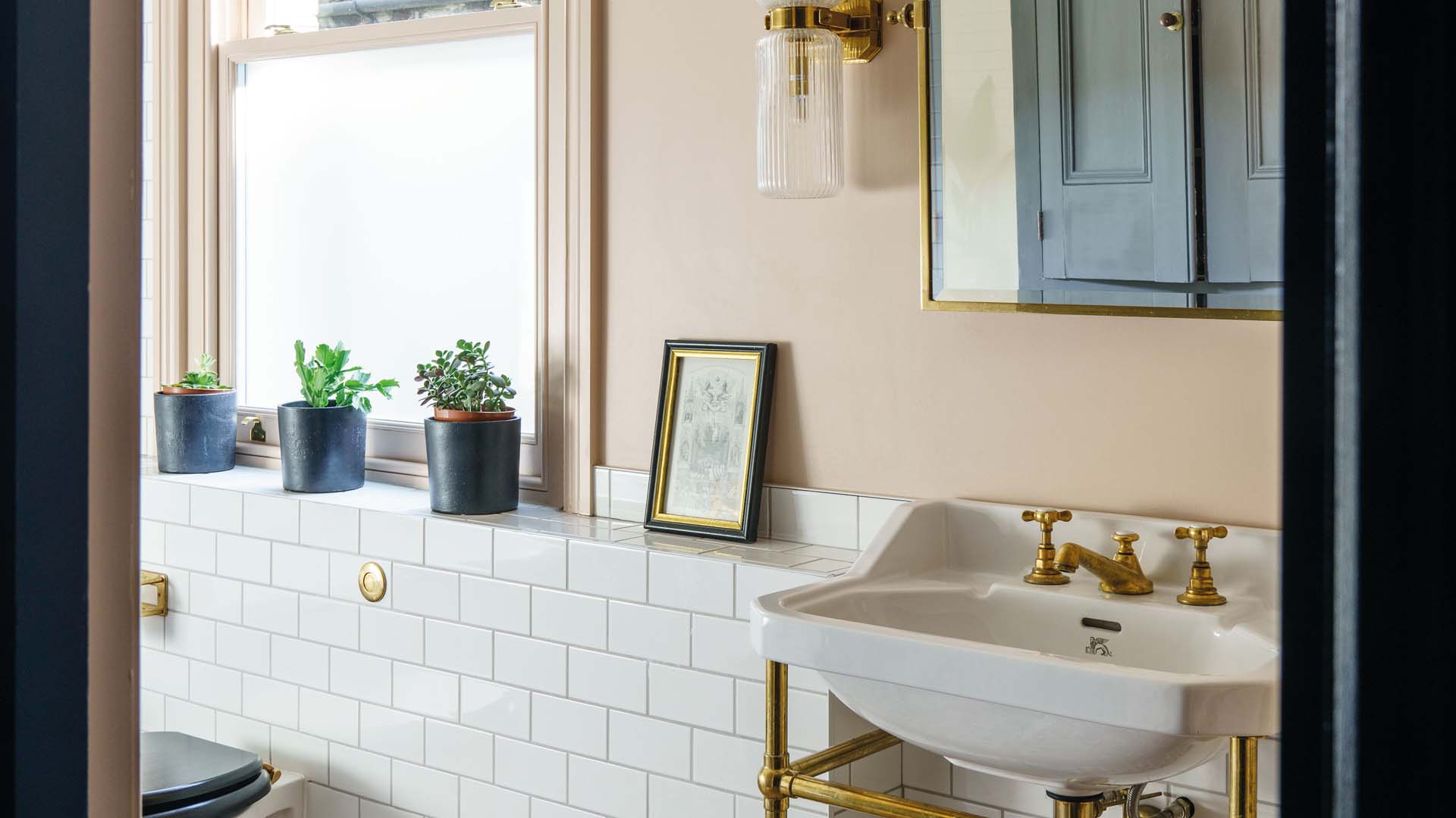 A calming bathroom decorated in white and peach tones