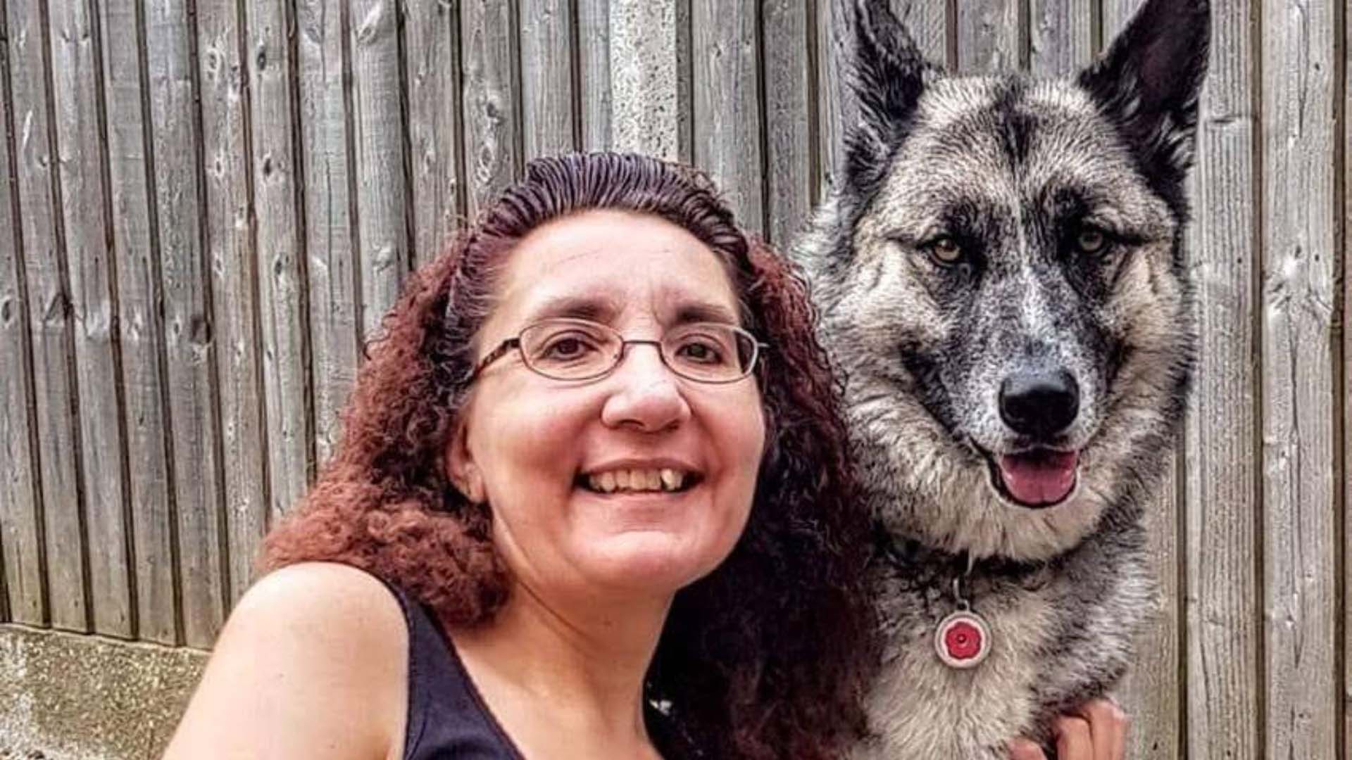 A woman next to her husky