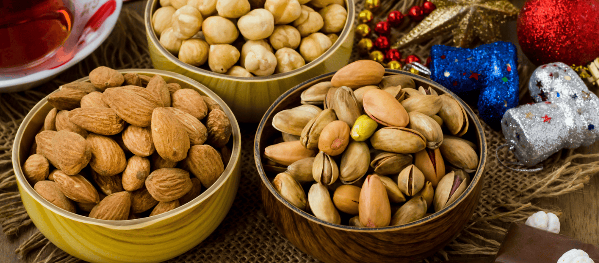 bowls of mixed nuts with a festive backdrop