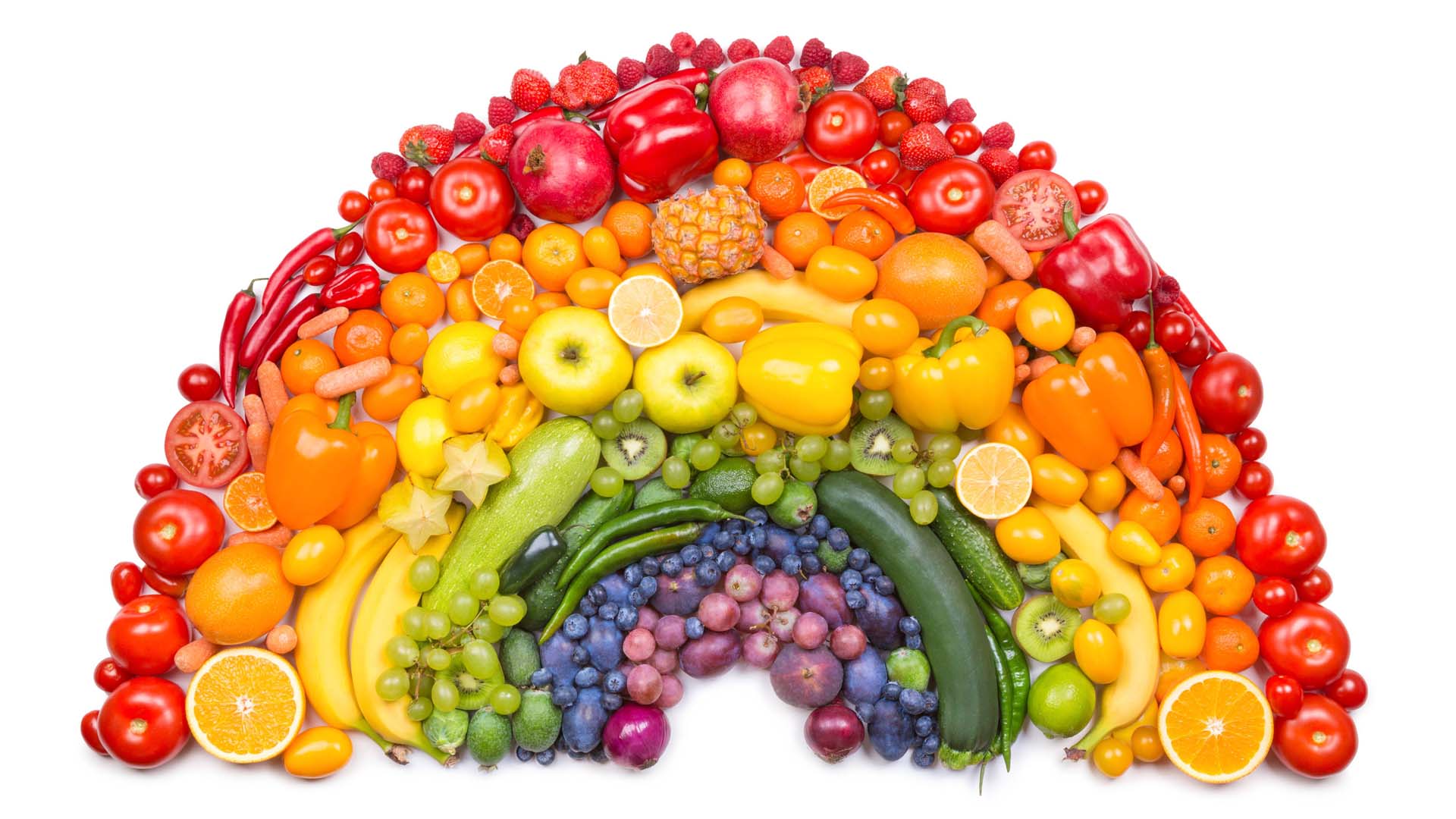 Colourful fruit and vegetables arranged in a rainbow shape