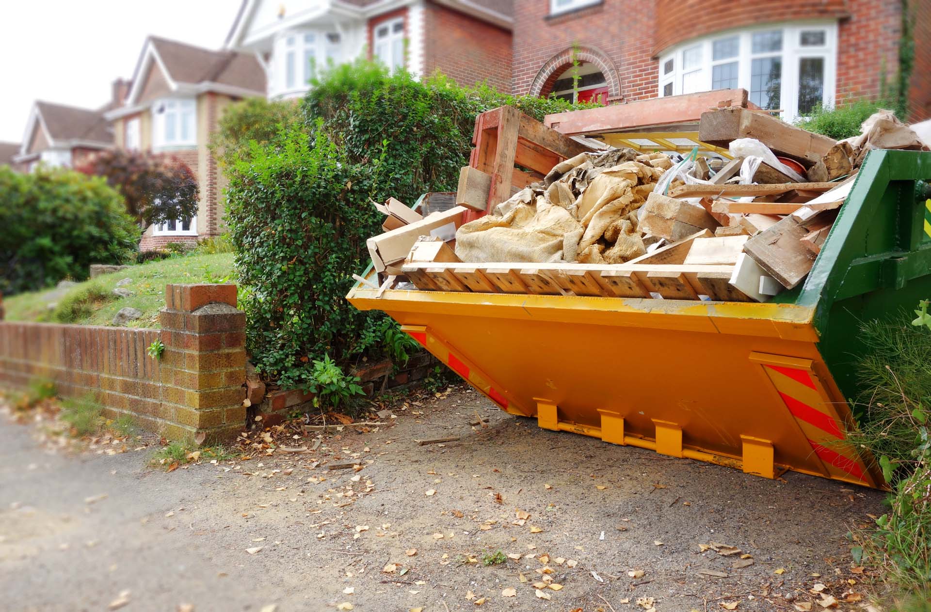 A filled skip on a driveway