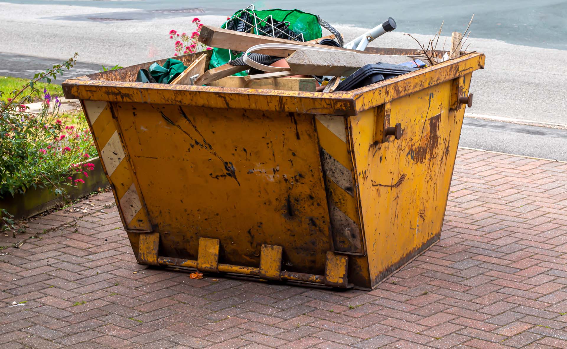 A skip on a driveway