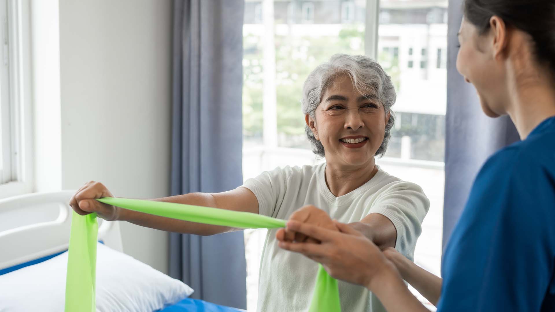 Nurse teaching patient how to use resistant bands