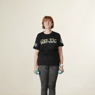 Woman lifting a pair of dumbbells out to the side